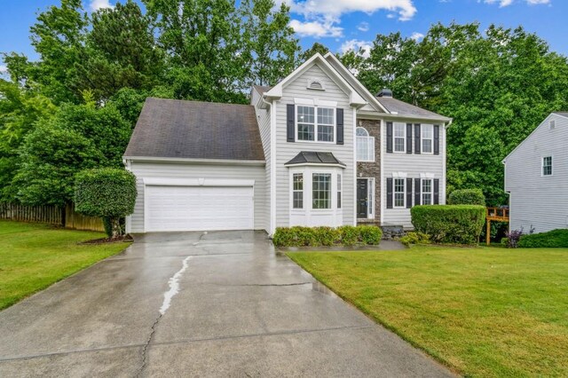 570 White Stag Ct, Suwanee, GA 30024 - view of front facade with an attached garage, driveway, and a chimney