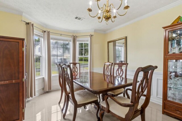 570 White Stag Ct, Suwanee, GA 30024 - dining area featuring a chandelier, ornamental molding, light tile patterned flooring, wainscoting, and a textured ceiling