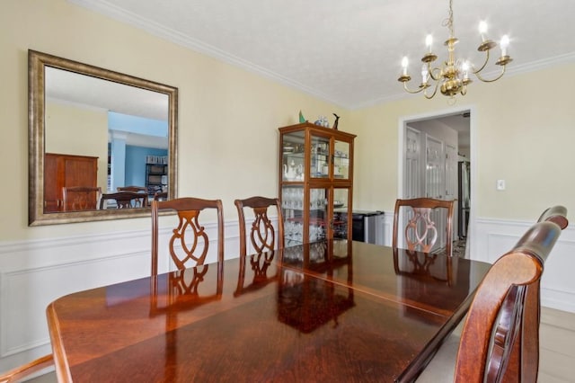 570 White Stag Ct, Suwanee, GA 30024 - dining space with a chandelier, ornamental molding, wainscoting, and a decorative wall
