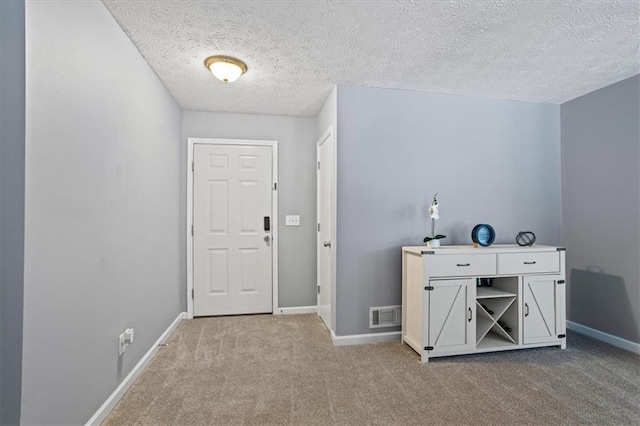 2711 Bluffton Rd, Buford, GA 30519 - foyer with carpet flooring and a textured ceiling