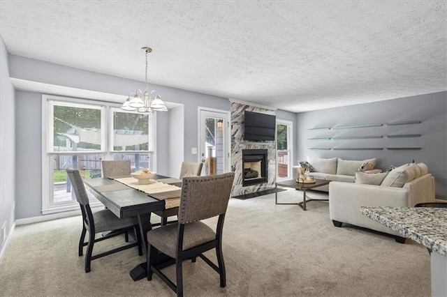 2711 Bluffton Rd, Buford, GA 30519 - dining area with light carpet, a chandelier, a textured ceiling, a stone fireplace, and healthy amount of natural light