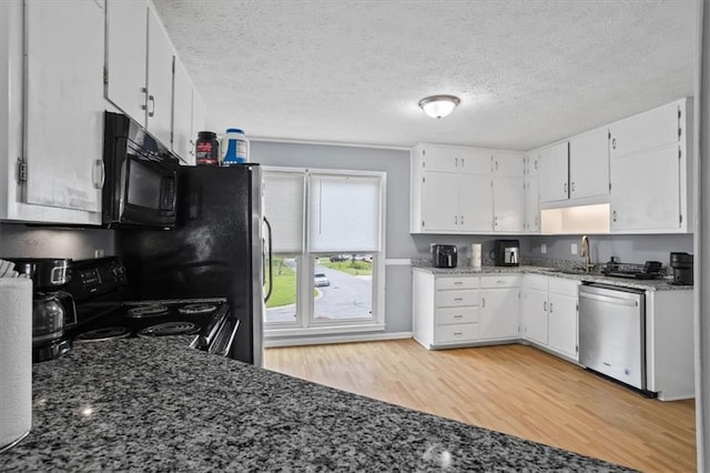 2711 Bluffton Rd, Buford, GA 30519 - kitchen with black appliances, light wood-type flooring, white cabinets, dark stone countertops, and a textured ceiling
