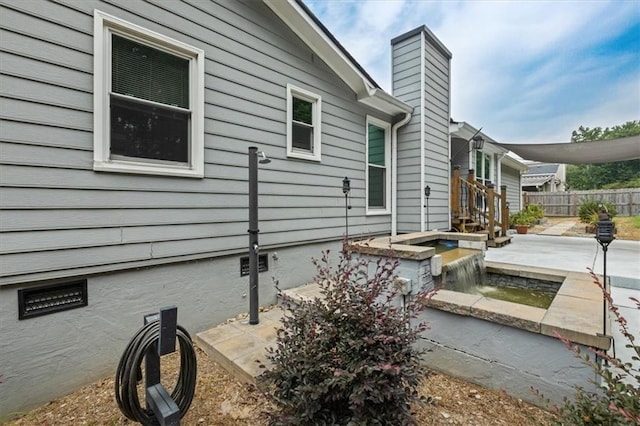 2711 Bluffton Rd, Buford, GA 30519 - view of side of property with a patio area, a chimney, and crawl space