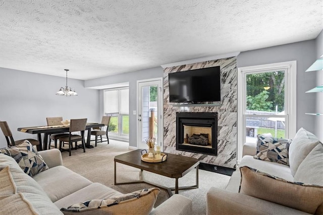 2711 Bluffton Rd, Buford, GA 30519 - living area with a high end fireplace, light carpet, a chandelier, and healthy amount of natural light
