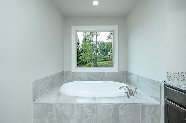 bathroom with a bath and vanity