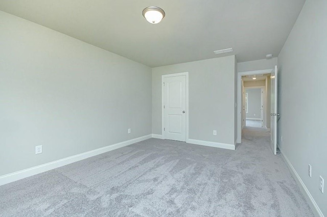 unfurnished bedroom with carpet floors and baseboards