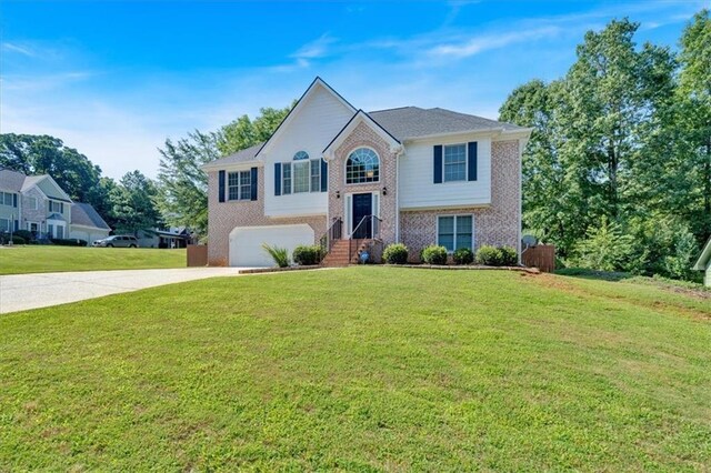 1331 Red Hill Rd, Marietta, GA 30008 - split foyer home with driveway, brick siding, a garage, and a front yard