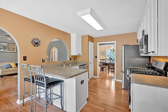 1331 Red Hill Rd, Marietta, GA 30008 - kitchen with appliances with stainless steel finishes, white cabinets, and light wood-style flooring