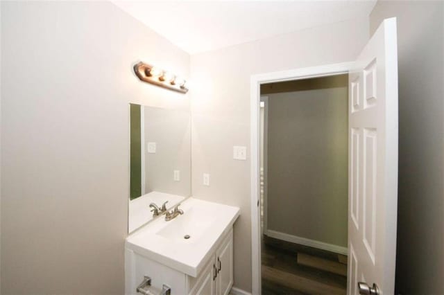 bathroom with hardwood / wood-style floors and vanity