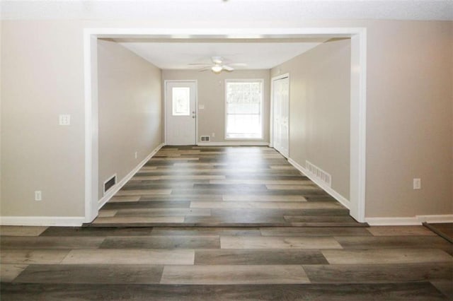 entryway featuring ceiling fan and dark wood-type flooring