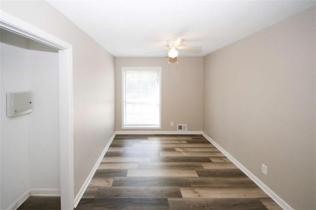 unfurnished room featuring ceiling fan and dark hardwood / wood-style flooring