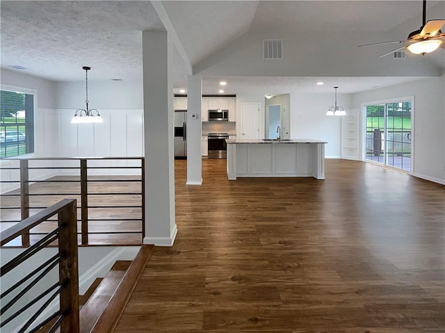 kitchen with stainless steel appliances, open floor plan, visible vents, and dark wood finished floors
