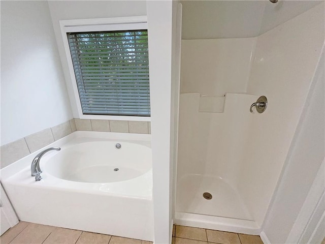 bathroom with a walk in shower, tile patterned floors, and a garden tub