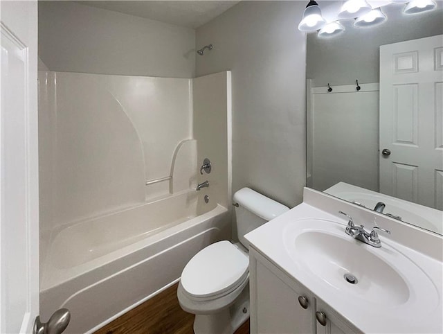 bathroom featuring shower / bath combination, wood finished floors, toilet, and vanity