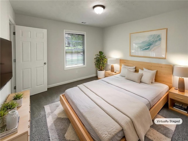carpeted bedroom featuring baseboards and visible vents
