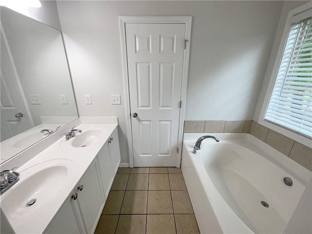 bathroom featuring tile patterned flooring, a sink, and a bath