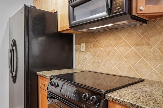 kitchen with tasteful backsplash, light stone countertops, and black appliances