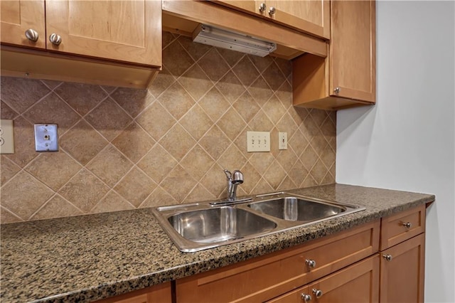 kitchen with tasteful backsplash and a sink