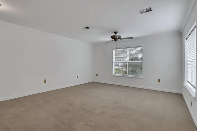 spare room with light carpet, ornamental molding, and visible vents