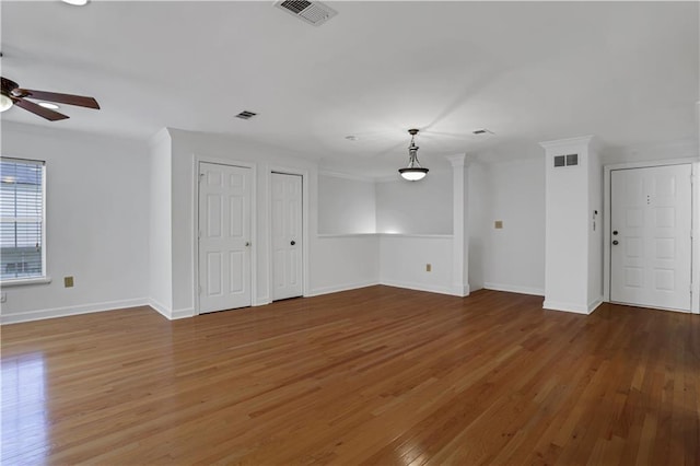 unfurnished living room with visible vents, ceiling fan, and wood finished floors