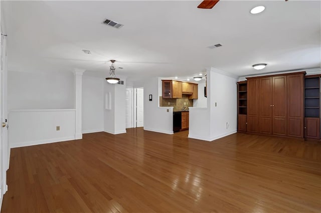 unfurnished living room featuring recessed lighting, visible vents, baseboards, and wood finished floors