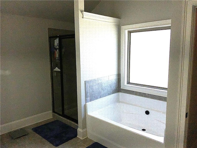 full bath featuring a shower stall, baseboards, and a bath