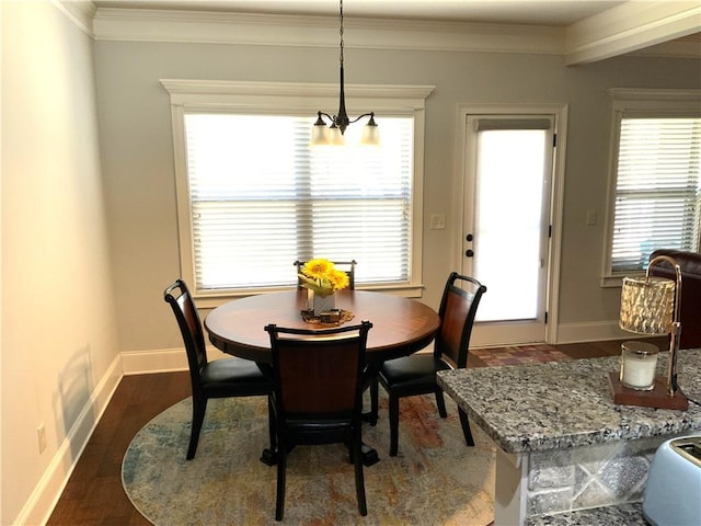 dining space with crown molding, dark wood finished floors, and baseboards