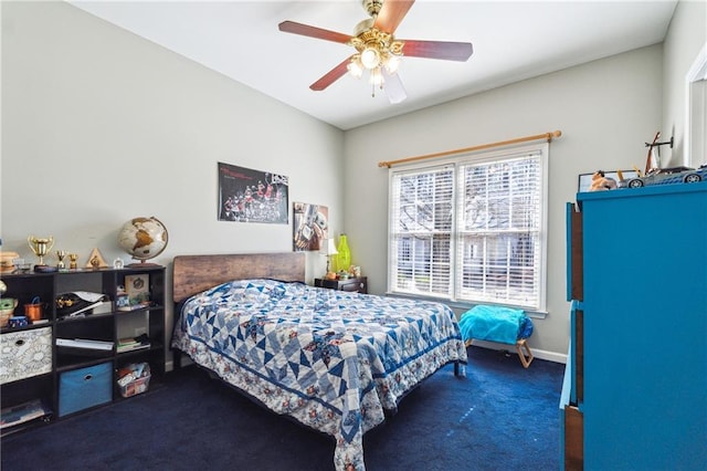 bedroom featuring baseboards, dark carpet, and a ceiling fan