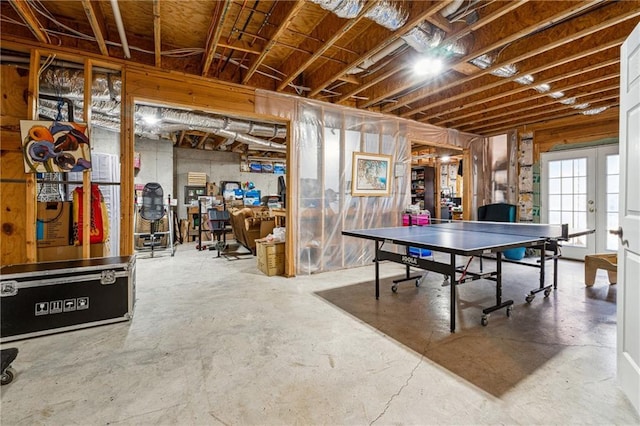 recreation room with concrete floors and french doors