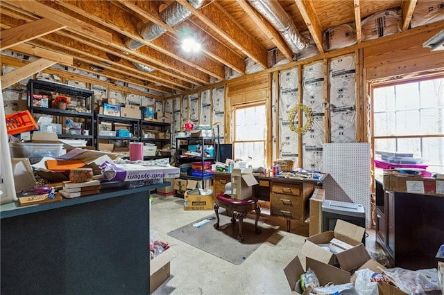 interior space featuring a healthy amount of sunlight, concrete flooring, and a workshop area