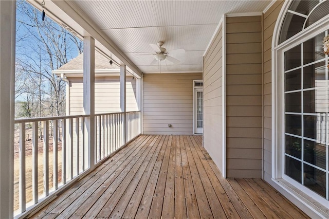 wooden terrace featuring a ceiling fan