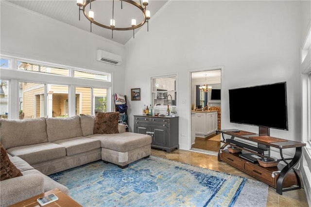 living room with baseboards, an inviting chandelier, a towering ceiling, and a wall mounted AC