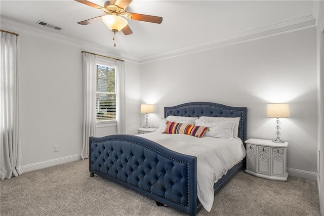 carpeted bedroom with a ceiling fan, crown molding, baseboards, and visible vents