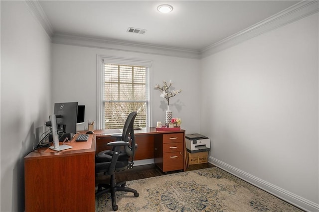 office with visible vents, wood finished floors, baseboards, and ornamental molding