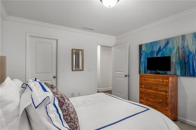 carpeted bedroom with visible vents, baseboards, and crown molding