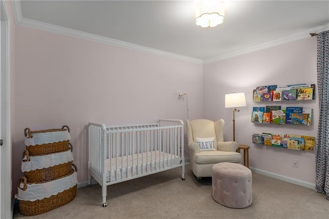 carpeted bedroom with a crib, baseboards, and ornamental molding