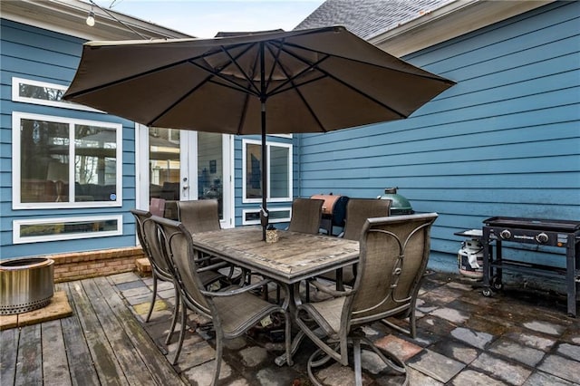 wooden terrace featuring outdoor dining space