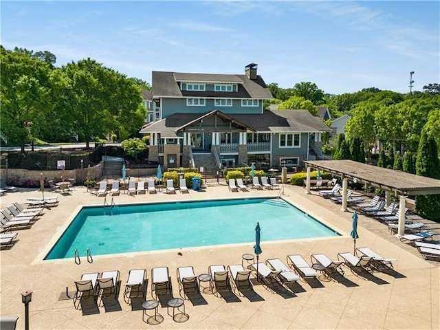 pool featuring a patio area and fence