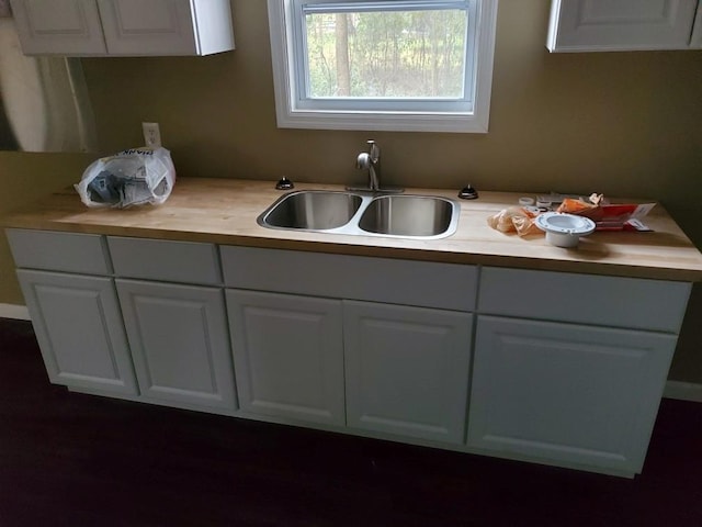 kitchen with white cabinetry and sink