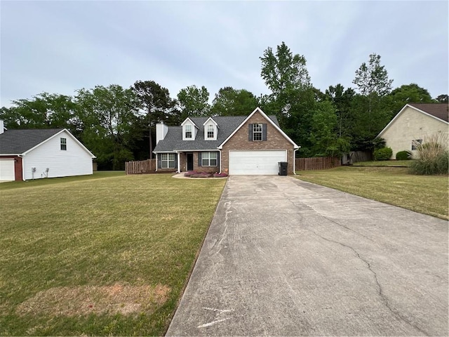 view of front of property with concrete driveway, a front lawn, fence, and brick siding