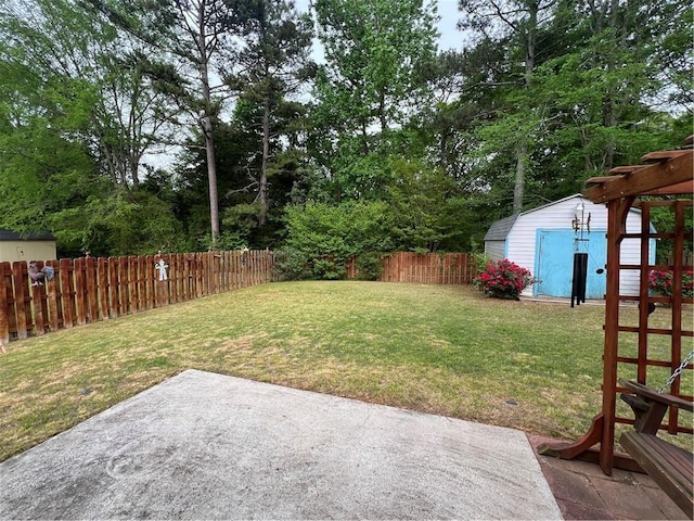 view of yard featuring a patio area, an outbuilding, a shed, and a fenced backyard