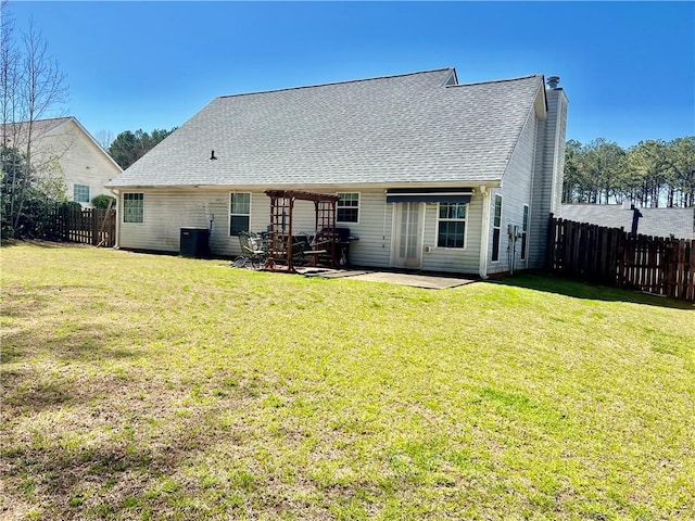 back of property featuring a yard, fence, and a patio area