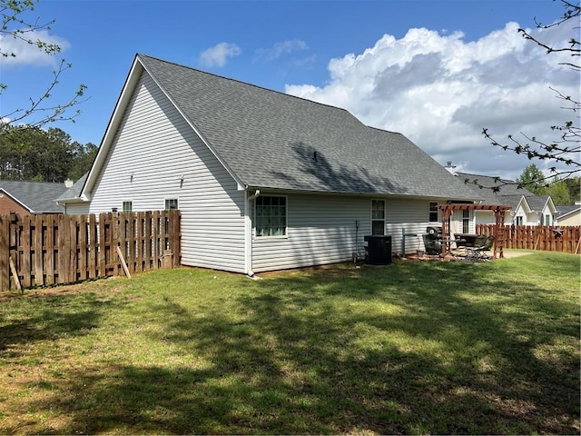back of house featuring a pergola, a shingled roof, a fenced backyard, a yard, and cooling unit