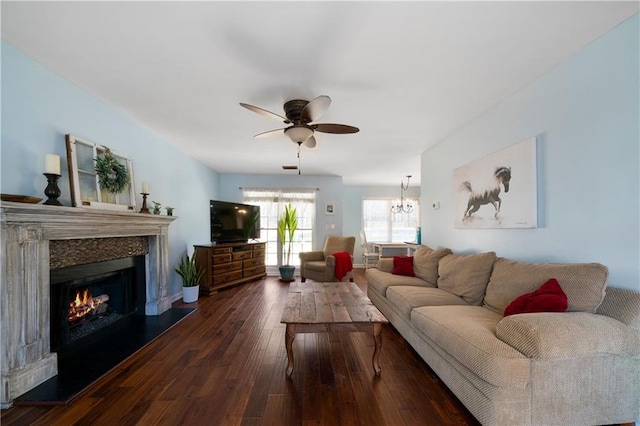 living room featuring dark hardwood / wood-style floors and ceiling fan with notable chandelier