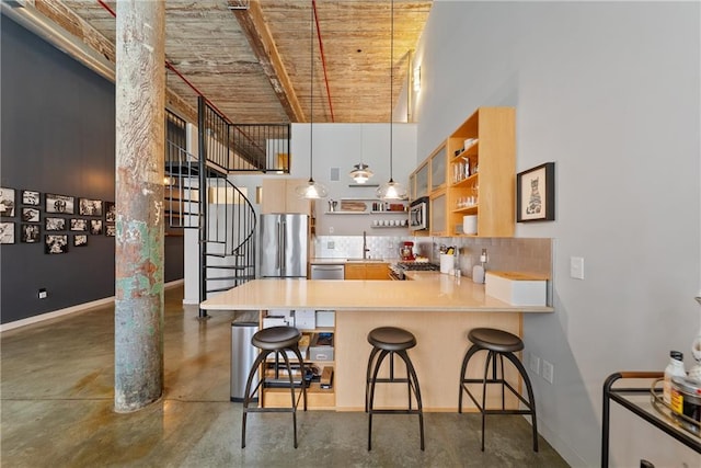 170 Boulevard Se E120, Atlanta, GA 30312 - kitchen with stainless steel appliances, open shelves, decorative backsplash, a towering ceiling, and a kitchen bar
