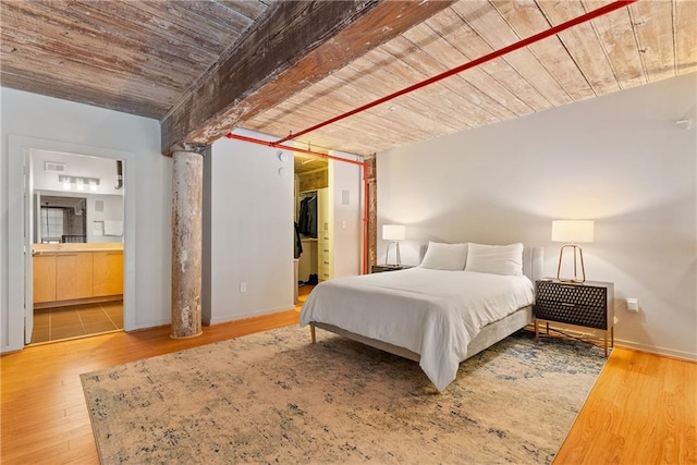 170 Boulevard Se E120, Atlanta, GA 30312 - bedroom featuring wood finished floors, a wooden ceiling with exposed beams, connected bathroom, and a spacious closet
