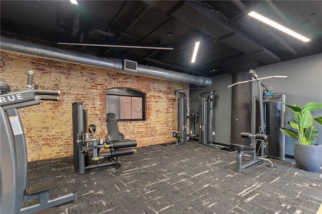 170 Boulevard Se E120, Atlanta, GA 30312 - exercise room with brick wall, carpet flooring, and water heater
