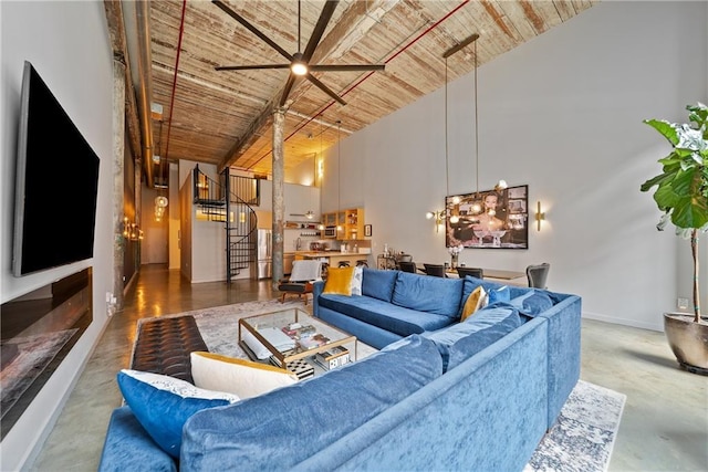 170 Boulevard Se E120, Atlanta, GA 30312 - living area with wooden ceiling, stairway, concrete flooring, a towering ceiling, and a ceiling fan