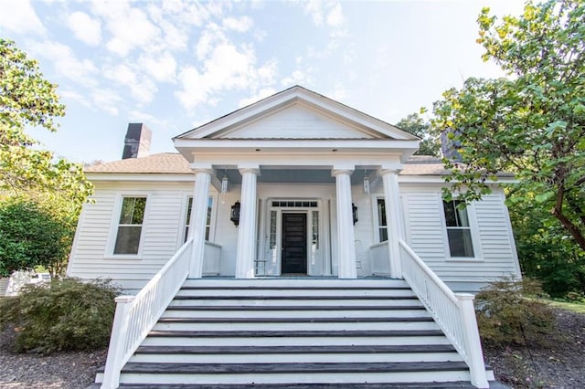 greek revival inspired property featuring covered porch