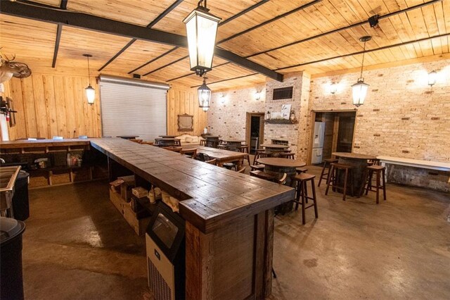 bar featuring brick wall, wooden walls, decorative light fixtures, tile counters, and wooden ceiling